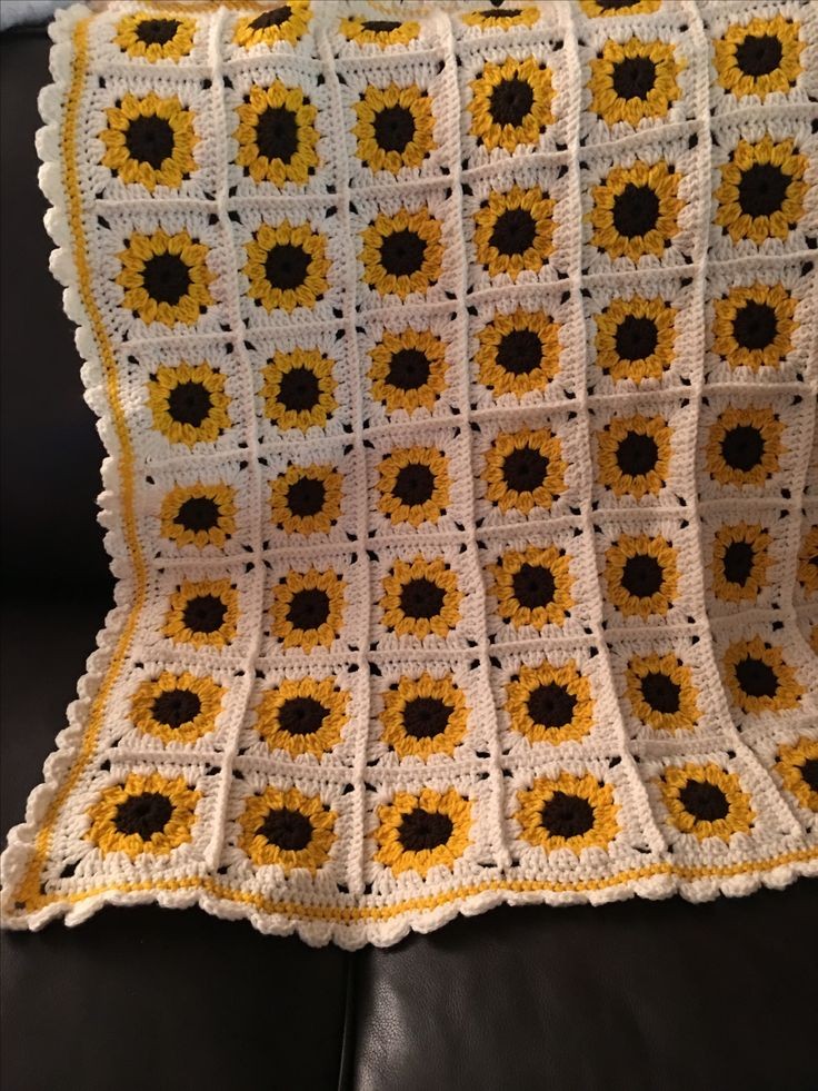 Crochet baby blanket in white granny squares with sunflowers