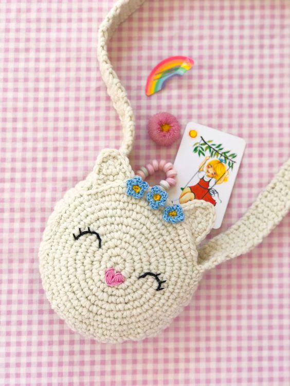 Crochet baby cat backpack with sleepy cat face and flowers