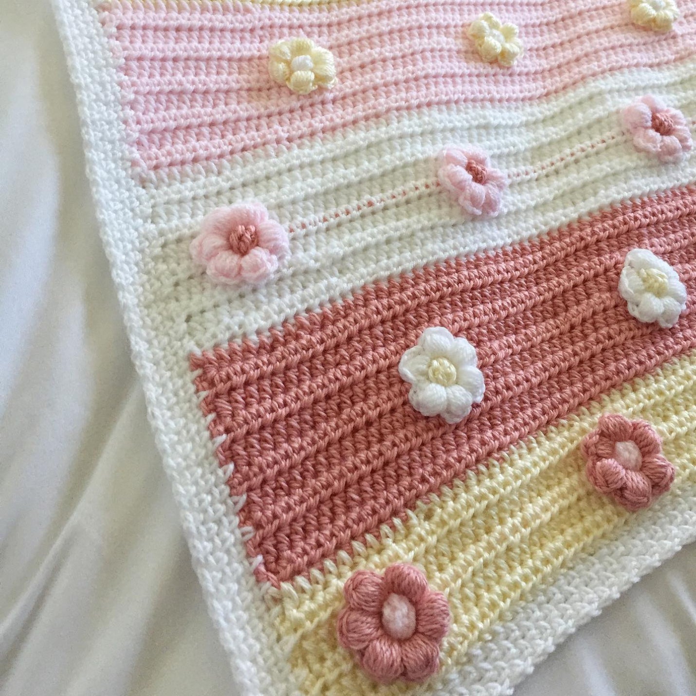 Crochet baby floral blanket in pink, cream and yellow with flowers