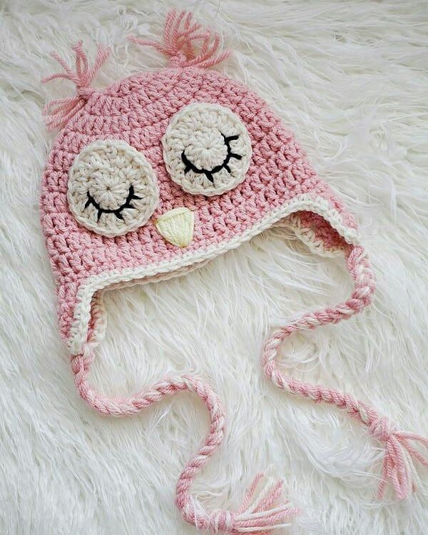 Crochet baby owl cap in pink with a sleepy owl face