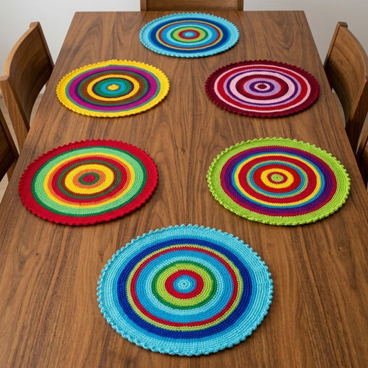 Set of 6 crochet colorful placemats laid out on a dining table