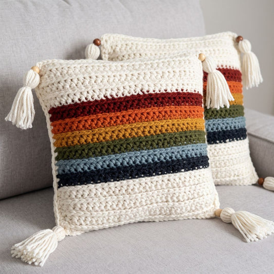 Crochet cushion cover in a cheerful, multi-colored rainbow design