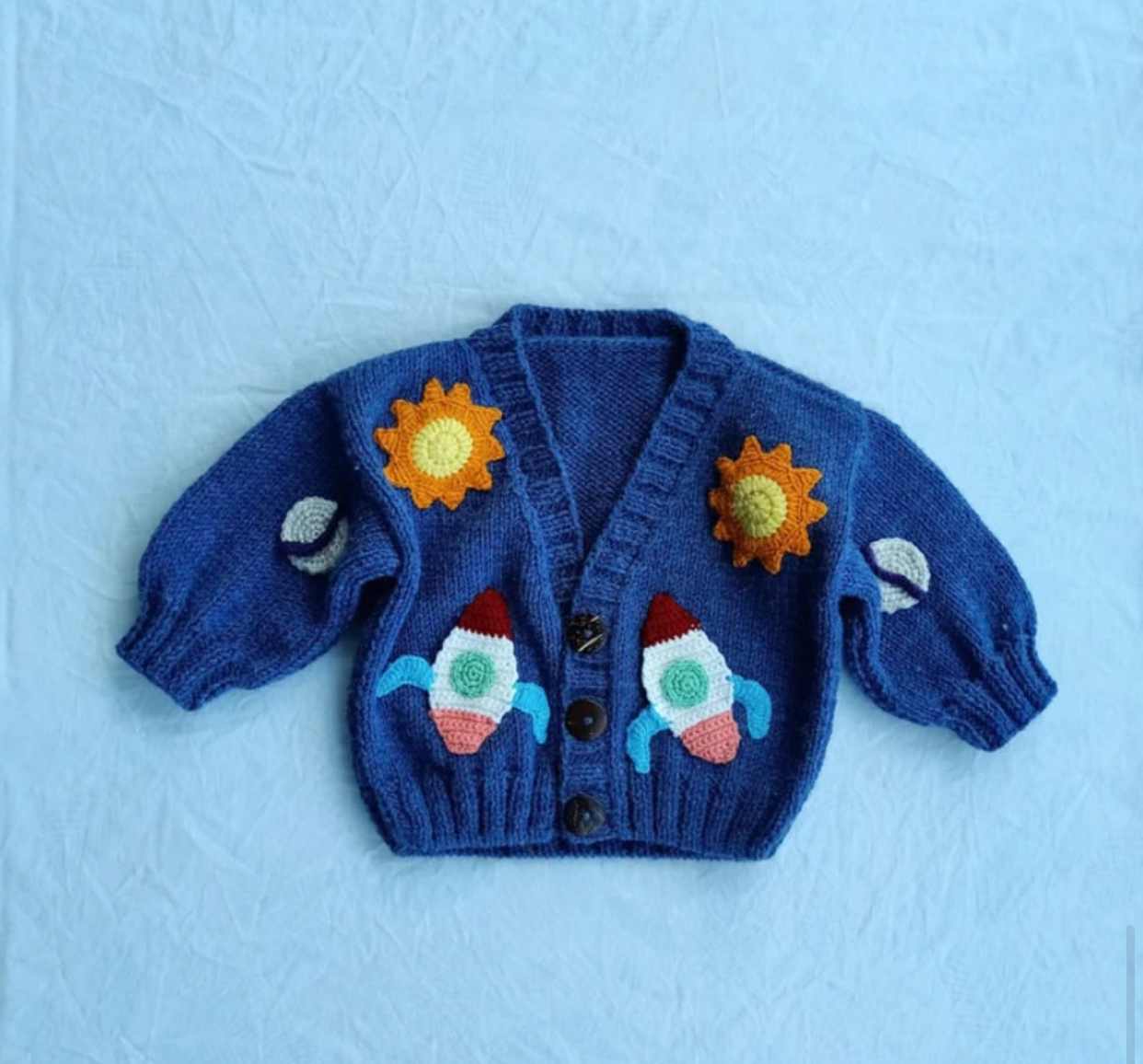 Crochet baby boy navy cardigan with 3D rockets, suns and planets