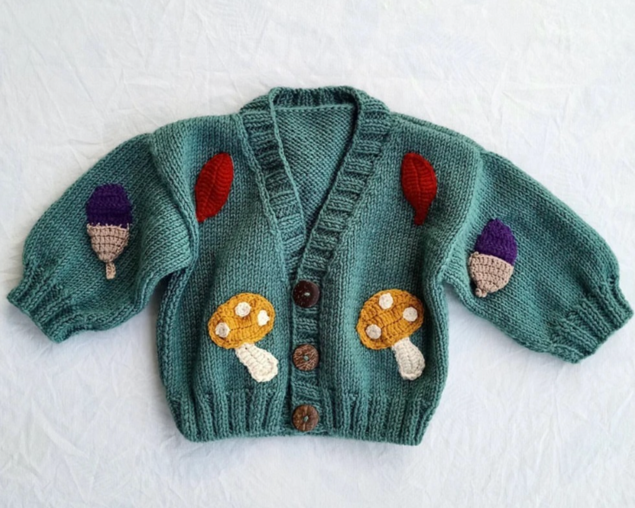 Crochet baby cardigan with mushroom appliqué in teal