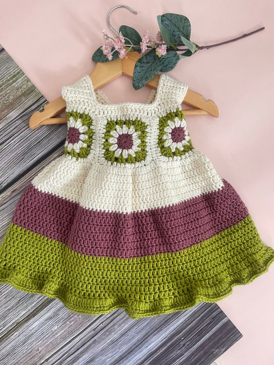 Crochet baby girl dress with floral granny square bodice and maroon and green tiered skirt