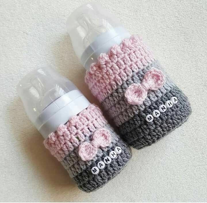Handmade crochet baby feeder cover in pink and blue with a heart