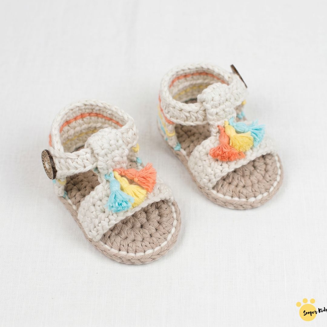 Cream crochet baby tassel sandals with coral, yellow and blue tassels