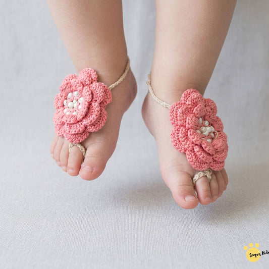 Handmade crochet baby girl barefoot flower sandals in coral with pearl detail