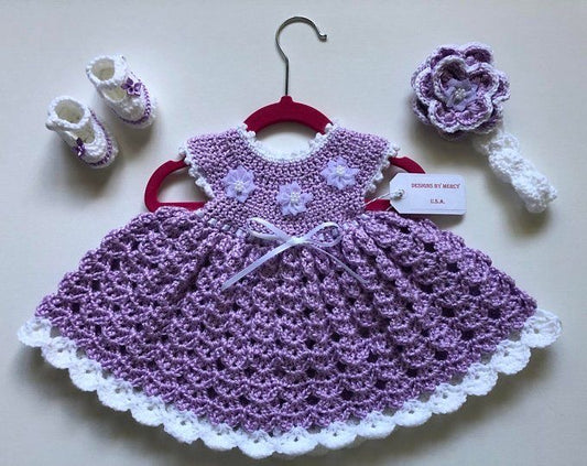 Handmade crochet baby girl lavender dress set with shell stitch skirt, satin ribbon, floral appliqué, matching booties and flower headband