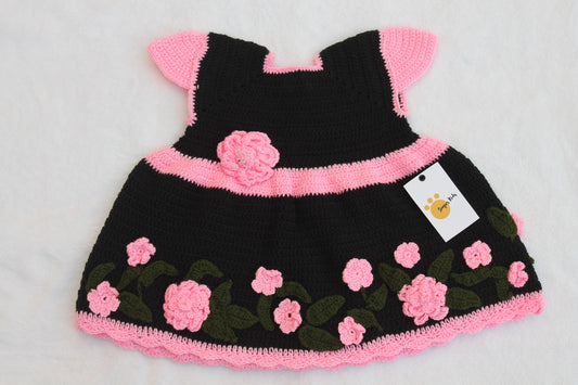 Handmade crochet baby girl dress in black with 3D pink roses, green leaf appliqué and scalloped hem