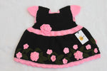 Handmade crochet baby girl dress in black with 3D pink roses, green leaf appliqué and scalloped hem