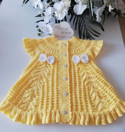 Handmade crochet baby girl yellow dress with leaf stitch pattern, ruffled cap sleeves, frilled hem and white bow detail
