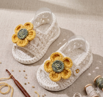 Handmade crochet baby girl sunflower sandals in white with yellow flower detail
