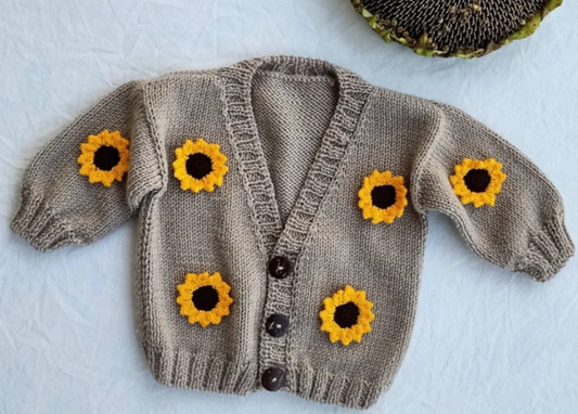 Handmade crochet baby cardigan in beige with 3D yellow sunflower appliqué and wooden buttons