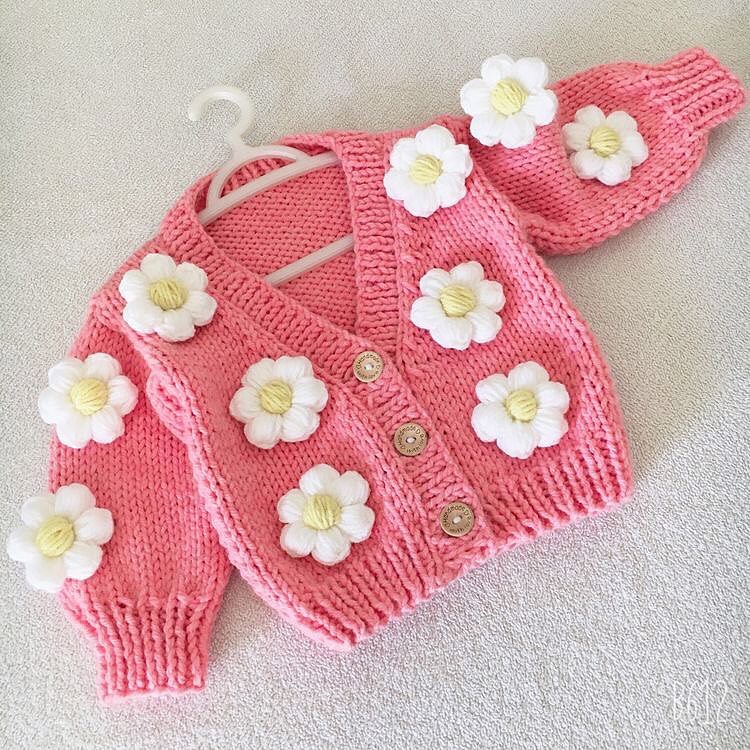 Crochet baby girl pink cardigan with white daisy flowers