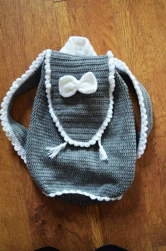 Crochet baby backpack in grey with white bow