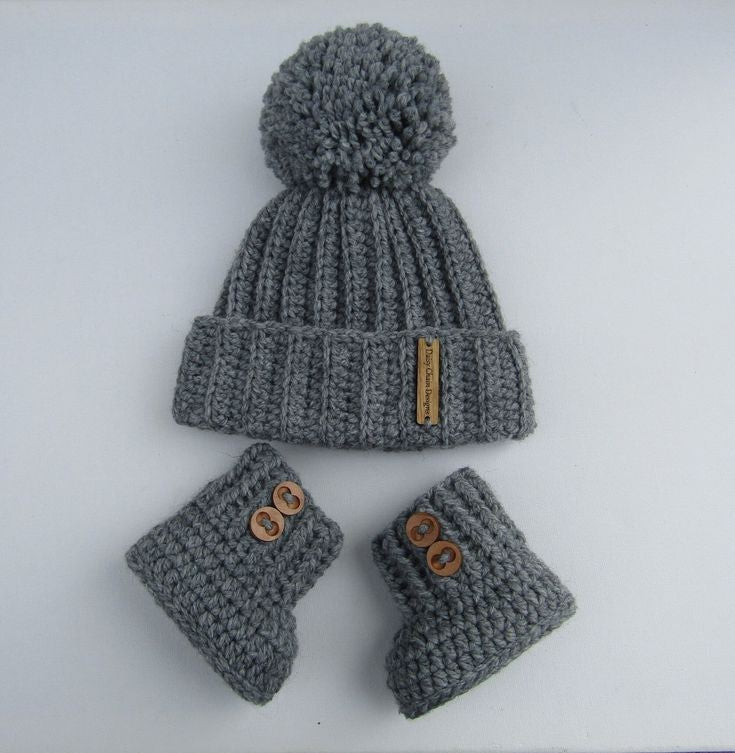 Crochet baby cap and booties set in grey with pom pom and wooden buttons