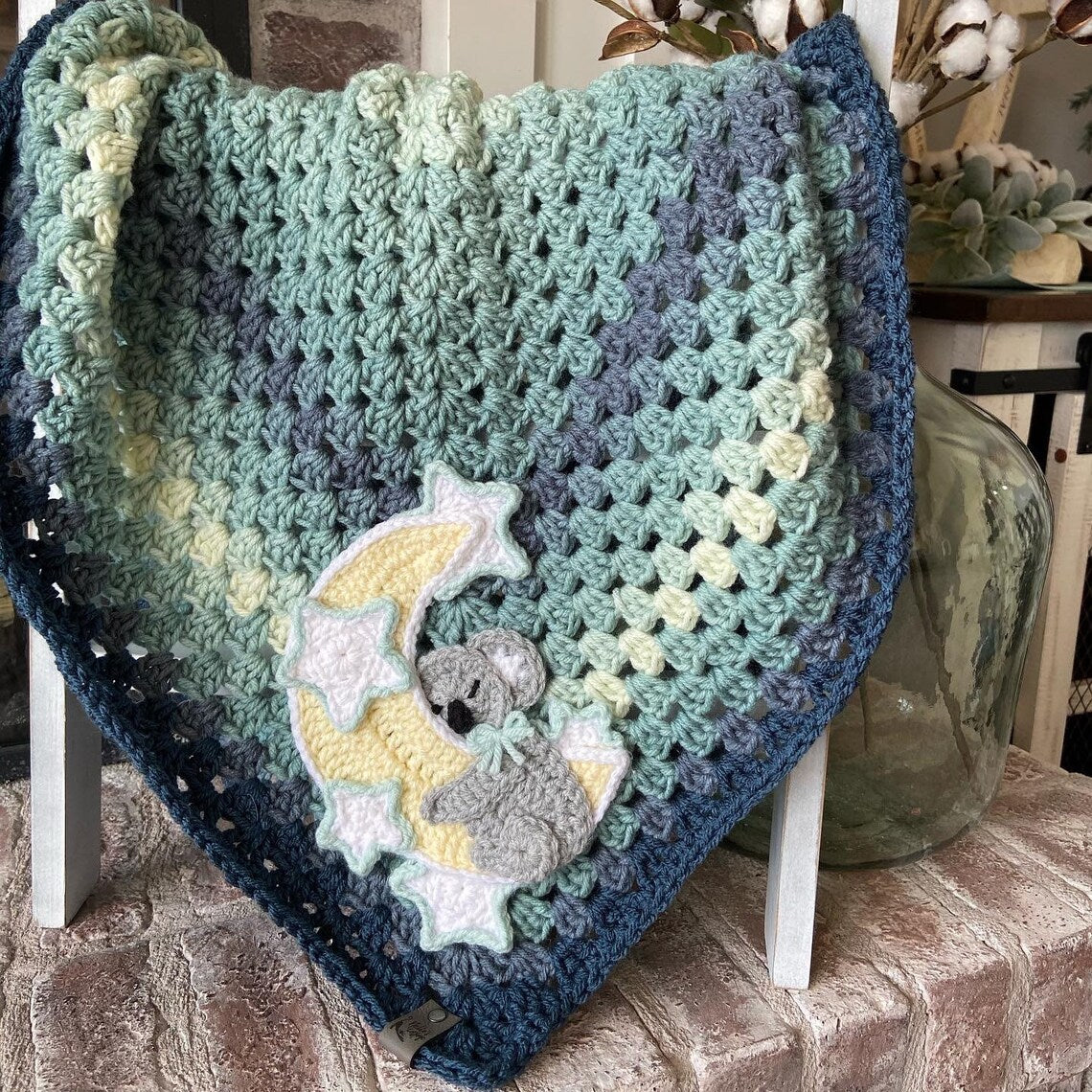 Crochet baby koala blanket in green with a koala on a moon