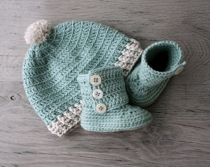 Crochet baby cap and booties set in mint green with cream pom and buttons