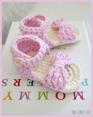 Pink and cream crochet baby sandals with a bow