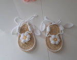Tan crochet baby sandals with white flower