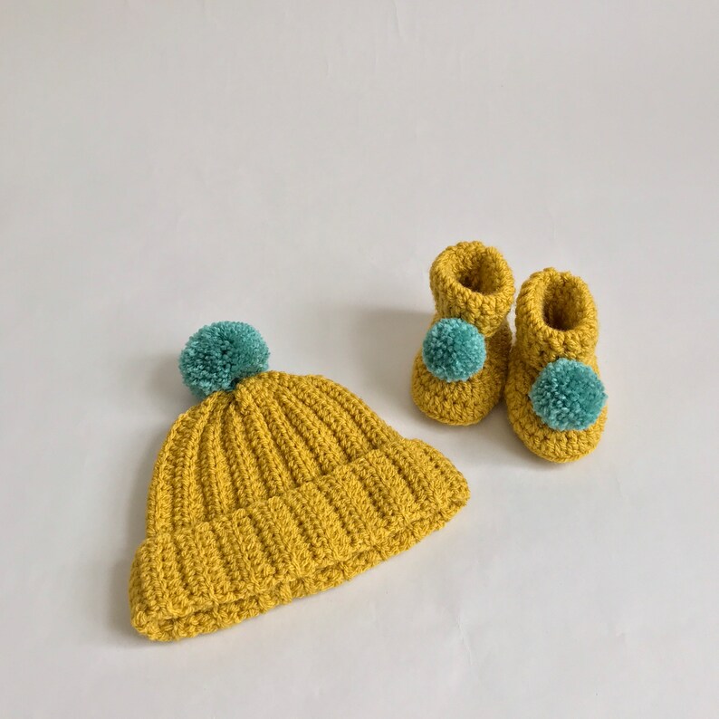 Yellow crochet baby cap and booties set, second view