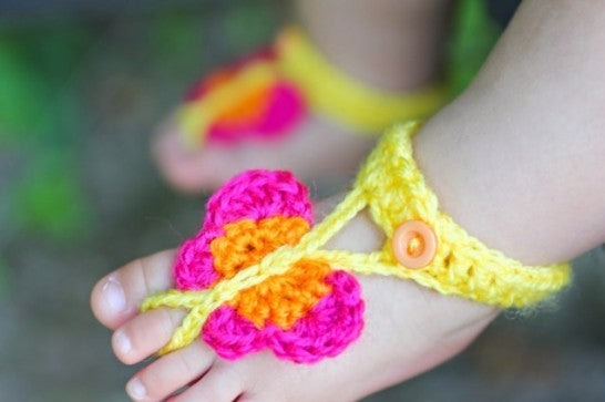 Crochet barefoot baby butterfly sandals in pink and orange on yellow straps