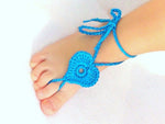 Blue crochet barefoot heart sandals with ankle ties on baby feet