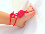 Shocking pink crochet barefoot heart sandals on baby feet