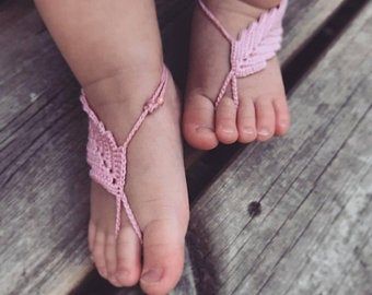Pink crochet barefoot baby petal sandals on baby feet