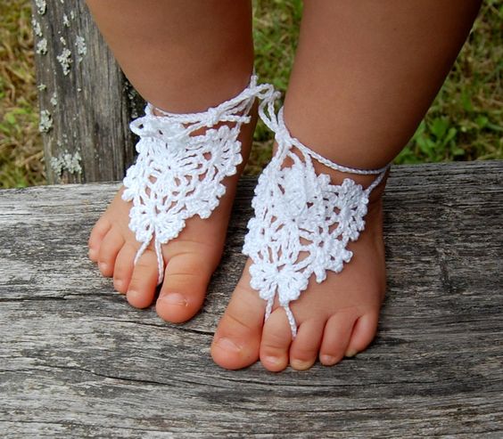 White lace crochet barefoot baby sandals on baby feet