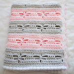 Handmade crochet baby blanket in grey and pink with dragonfly stitch detail
