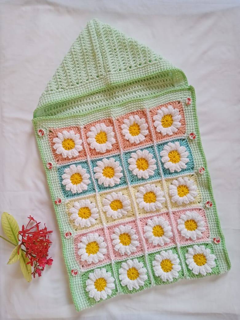 Handmade crochet baby daisy cocoon in green with pastel granny square pattern