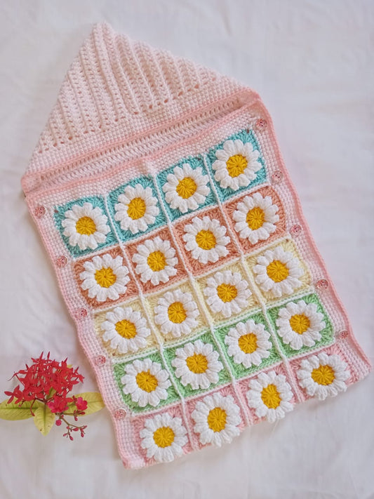 Handmade crochet baby sleeping bag with daisy granny square pattern in pink and multicolor