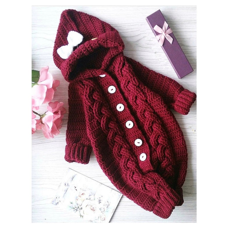 Handmade crochet baby girl hooded romper with bow detail in maroon