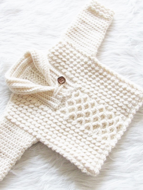 Handmade crochet baby hooded poncho sweater in cream with wooden button detail