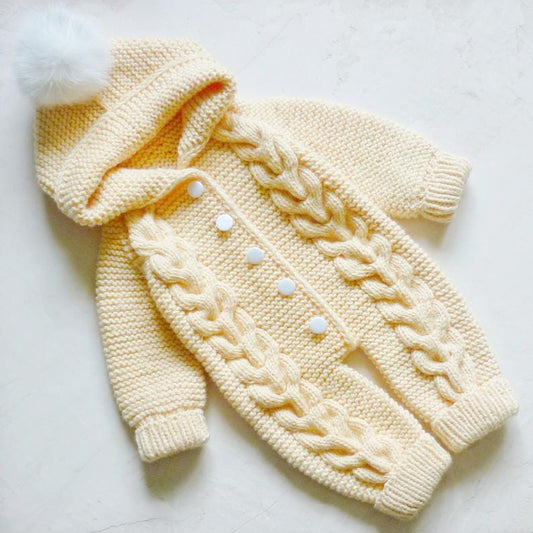 Handmade crochet baby hooded romper in cream with pom pom hood detail
